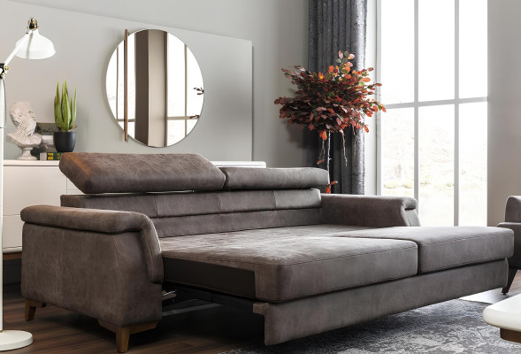 Grå soffa med tre platser och sängfunktion