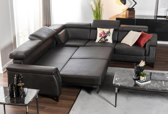 Svart L-formad soffa med sängfunktion