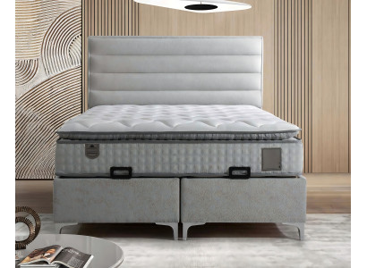 Säng i modern grå tyg med elegant madrass