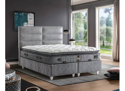 Säng i modern grå tyg med madrass