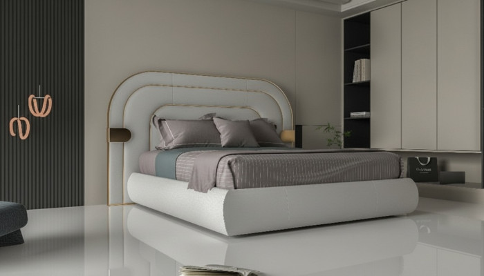 Lyxig grå sängram med gyllene detaljer i modern design och mjukt stoppning